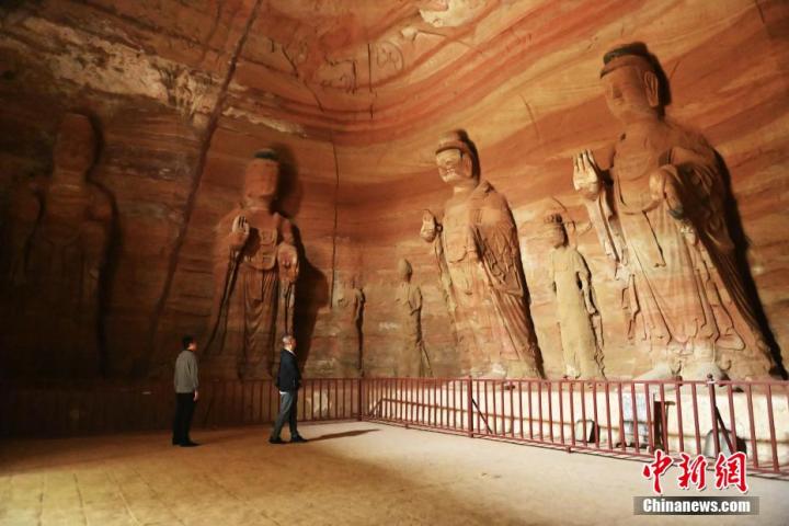 7月15日，游人參觀甘肅省平涼市涇川縣百里石窟長廊中的南石窟寺1號窟。百里石窟長廊位于涇川縣境內，由512個石窟、5眼窟中石井組成，現存王母宮石窟、鳳凰山石窟、南石窟寺、丈八寺石窟、羅漢洞石窟、太山寺石窟等規模較大的石窟群，還有數量眾多的小石窟群。南石窟寺開鑿于北魏永平三年，其中1號窟屬于大型七佛窟，七佛高達6米。中新社記者 李亞龍 攝